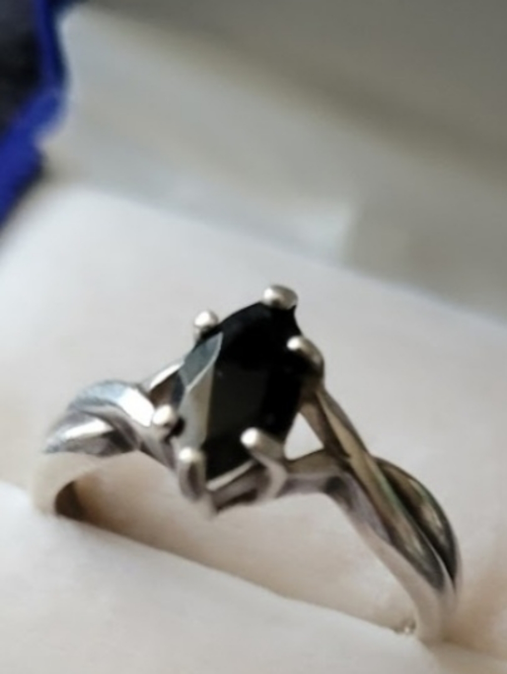 This is a vintage Avon sterling silver ring featuring a black marquise-cut stone